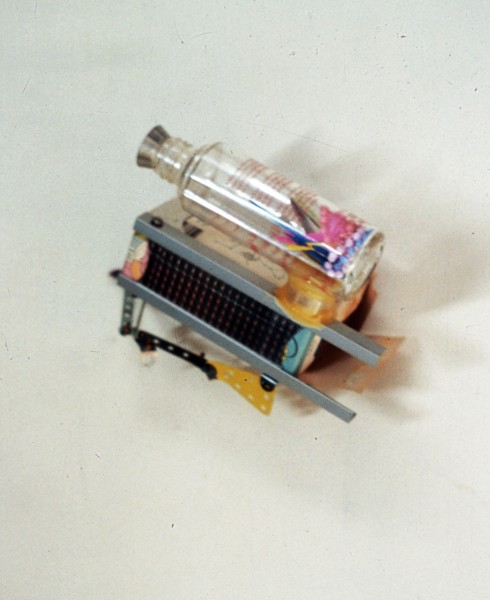 winter 1989. Materials: my face cream glass botle with plastic little girs jewelry inside+ bombom mould as cup+ aluminium+mecano structure with biscuit&amp;acute;s box with dots drawing in crayon